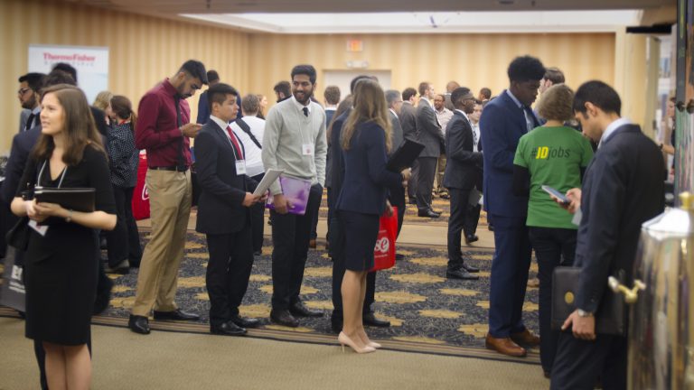 Students talk with potential employers during the job fair session