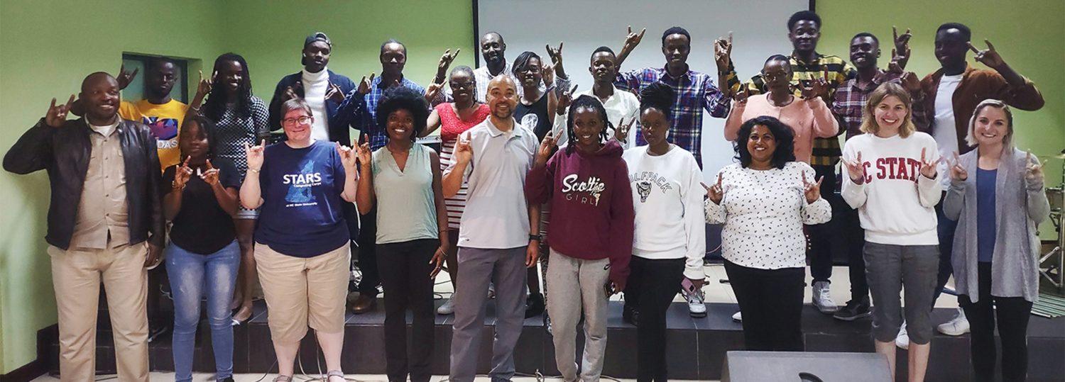 Professor Kanton Reynolds standing with a group of Rwandan students