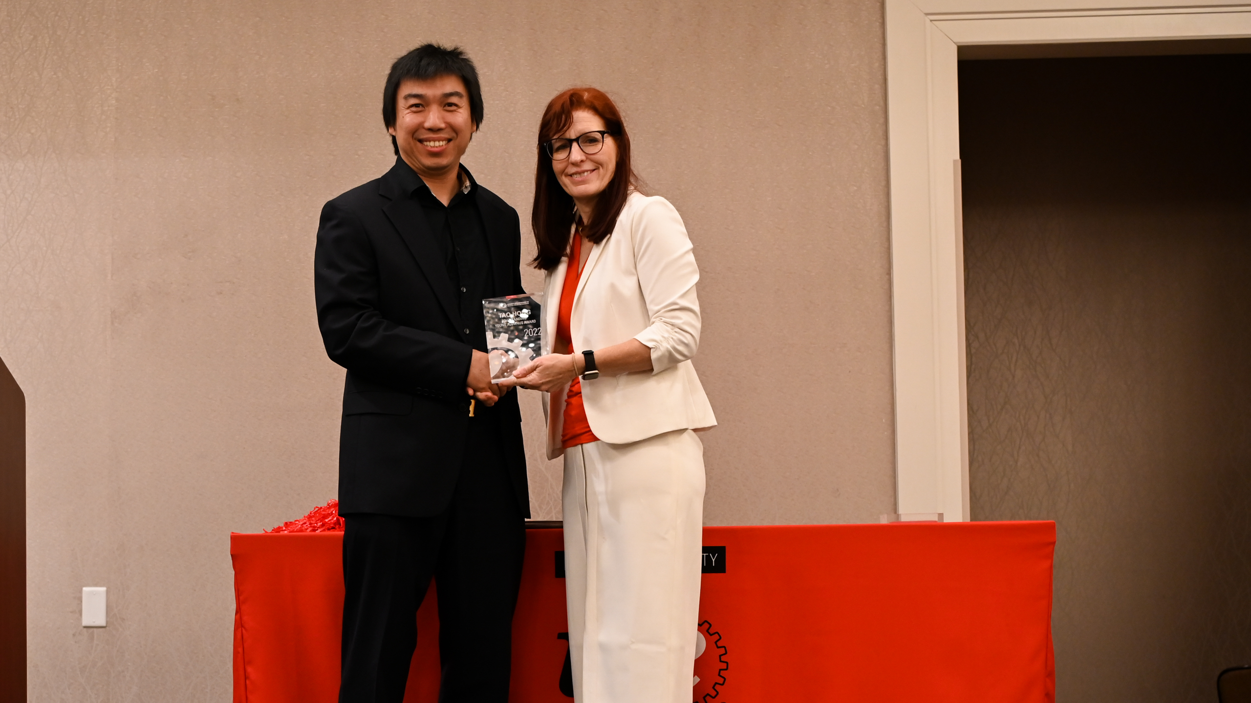 Outstanding Young Alumnus Dr. Tao Hong accepting his award from Dr. Julie Swann