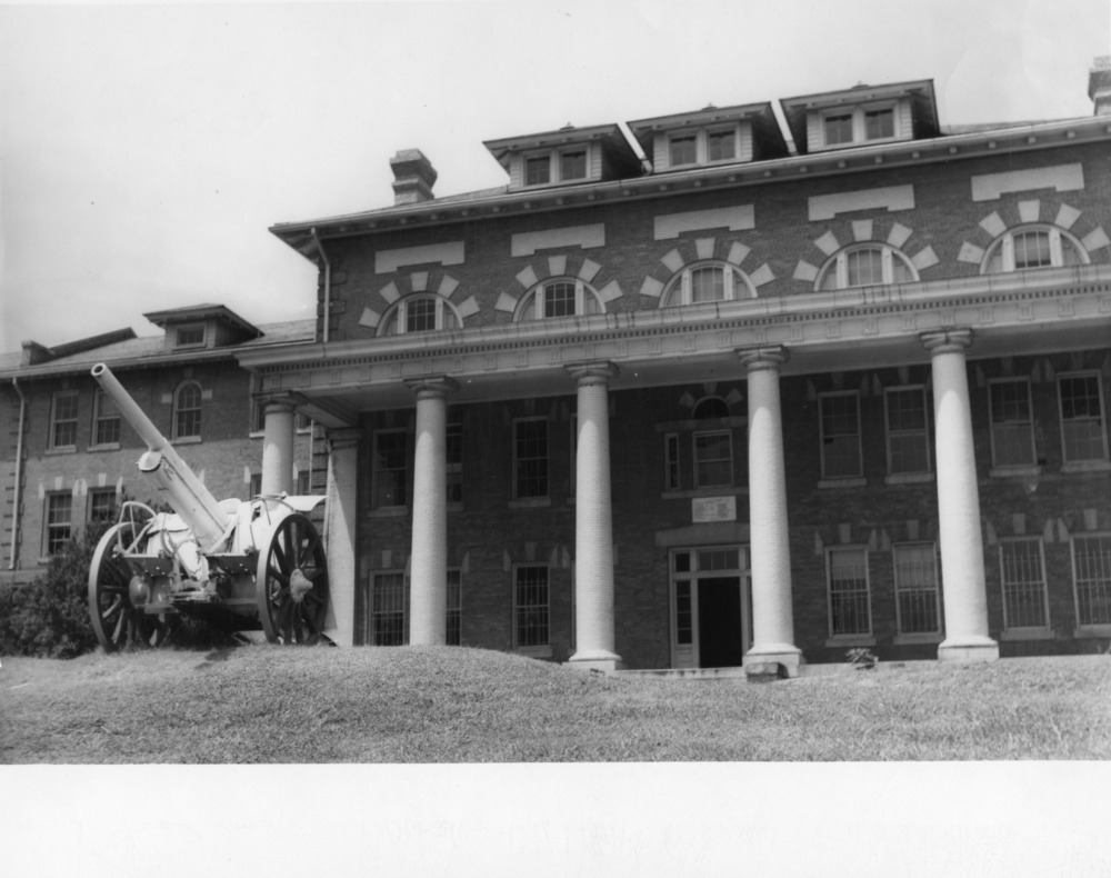 View of cannon in front of 1911 Building, North Carolina State College. The building was used as a dormitory from the time of its construction in 1909 until 1943.