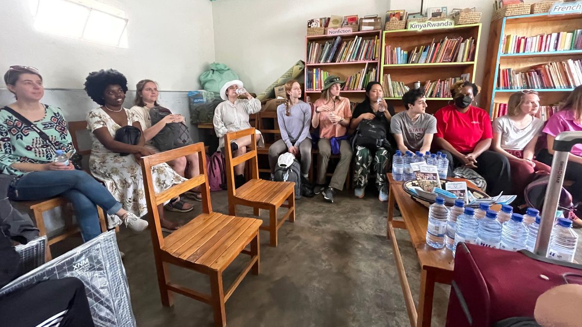 Picture of the team seated in the Nyamirambo Women's Center (NWC) where students learned about their mission to support local women.