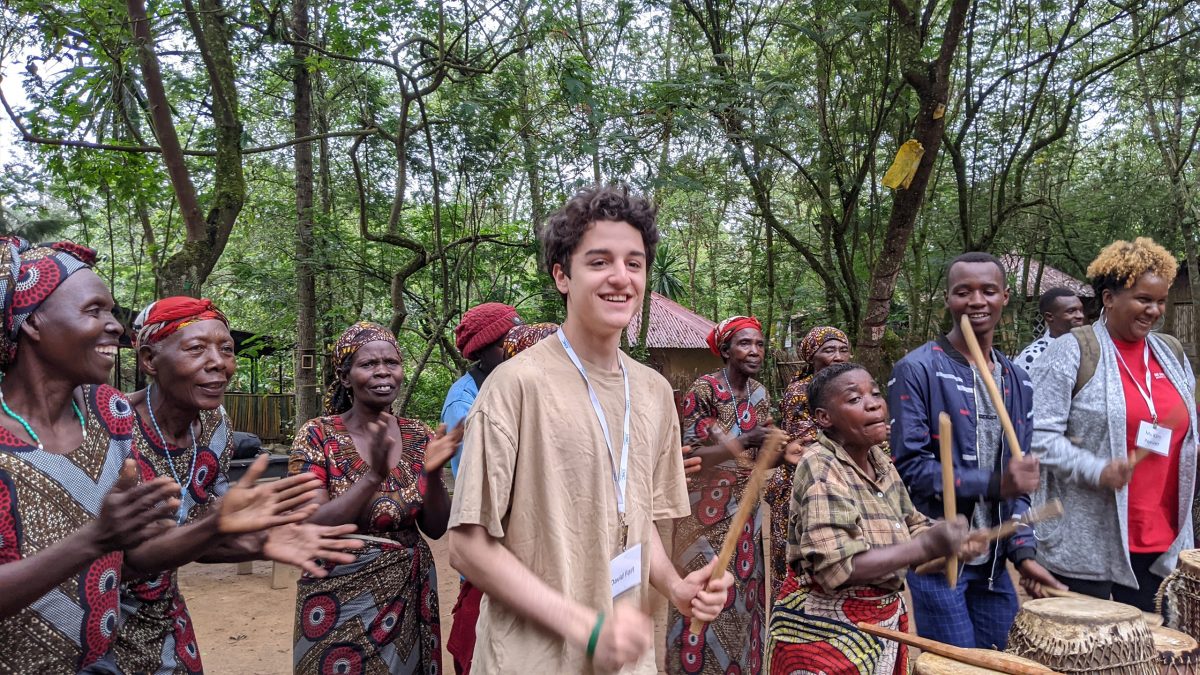 Freshman, David Fort, pictured learning how to drum with the women of the Red Rocks cultural center in Musanze.