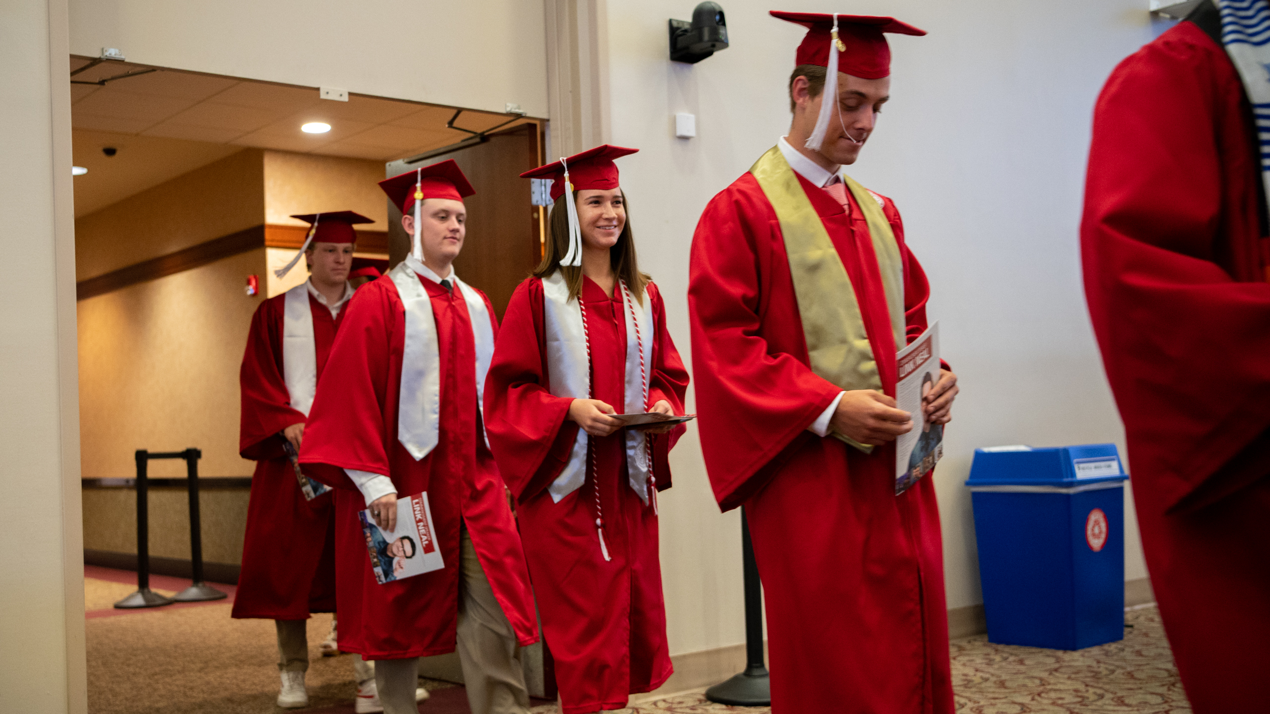 Undergraduates walking into commencement