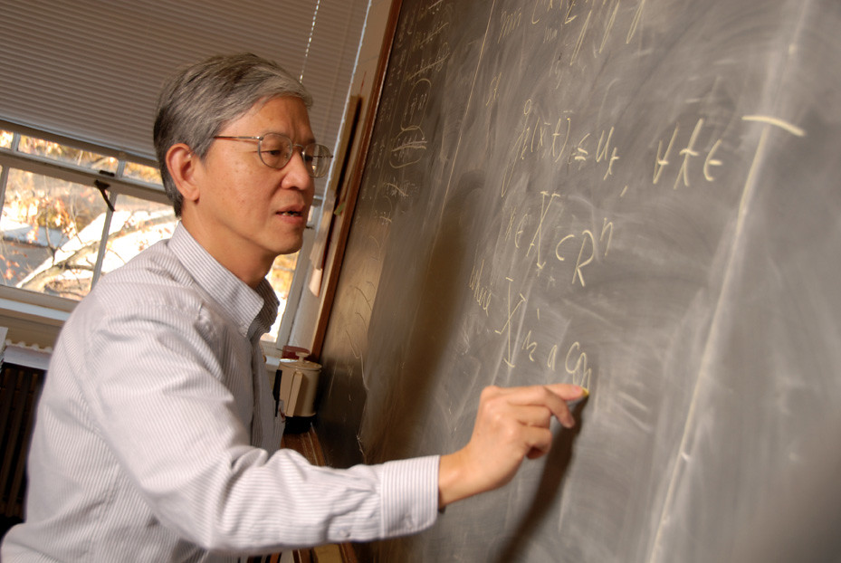 Shu-Cherng Fang writing on a blackboard